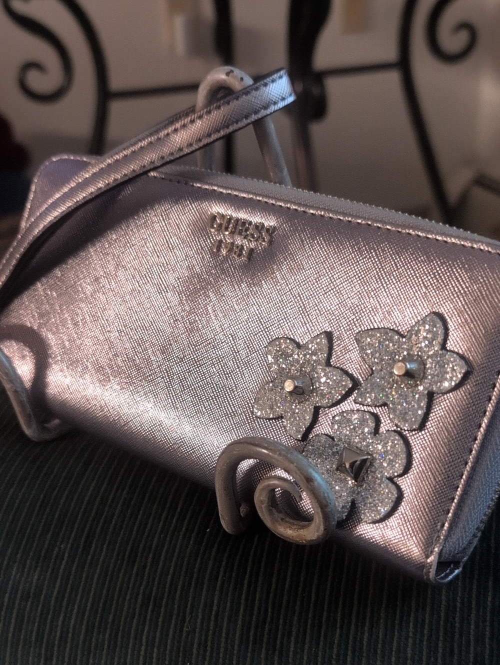 GUESS Metallic Silver Wristlet with Glitter Flower Accents